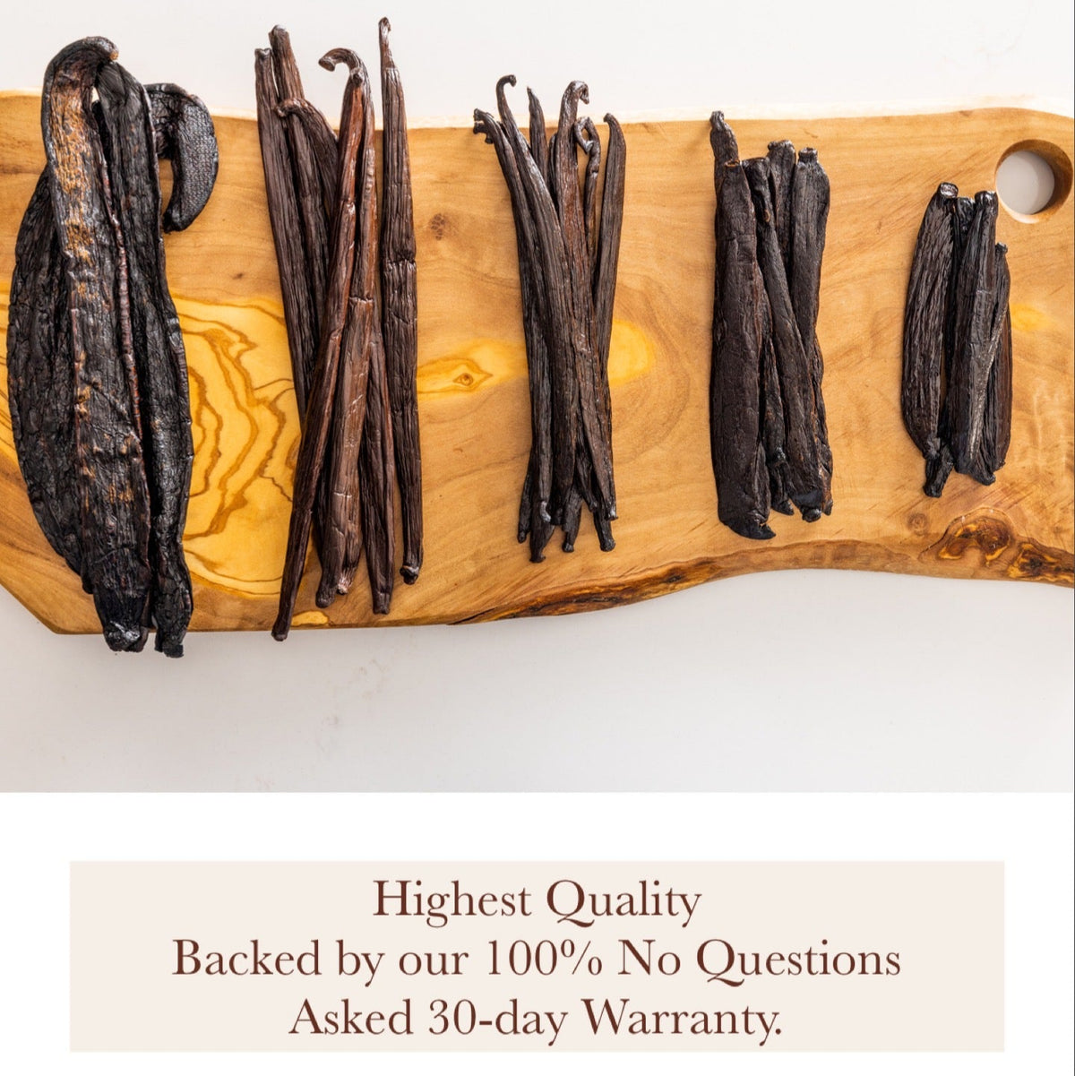 Colombian Vanilla Beans arranged on a wooden board, showcasing their highest quality and 30-day warranty guarantee.