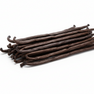 Loose pile of vanilla beans on white background