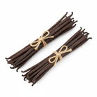 Two bundles of vanilla beans with twine